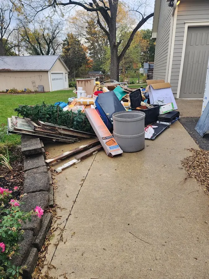 Dumpster being loaded with debris for 12 Yard Dumpster Rental in Newcastle